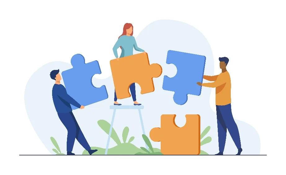 People connecting puzzle pieces